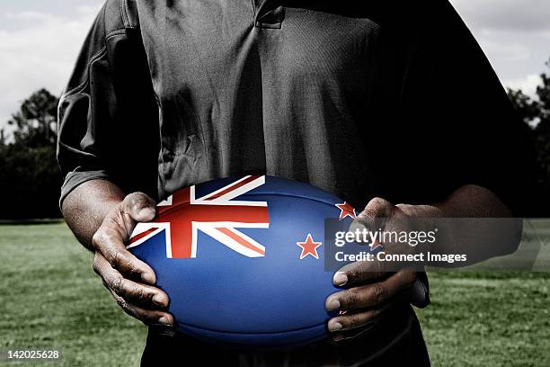 player holding rugby ball with new zealand flag - new zealand rugby stock pictures, royalty-free photos & images