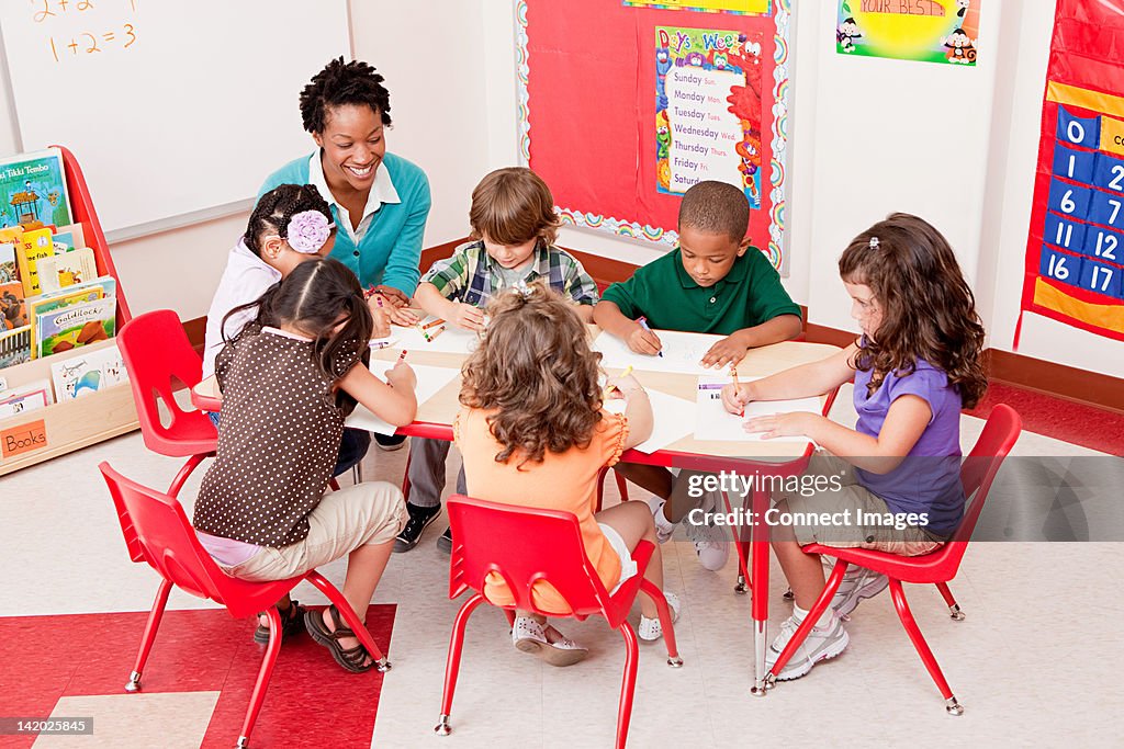 Teacher and children in school art class