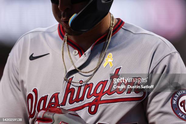 Childhood Cancer Awareness Day ribbon is seen on the jersey of Joey Meneses of the Washington Nationals during the first inning of the game between...