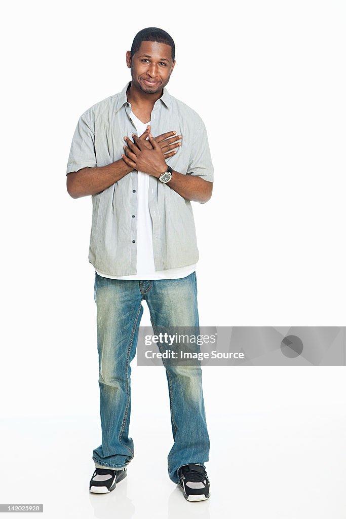 Mid adult man standing against white background