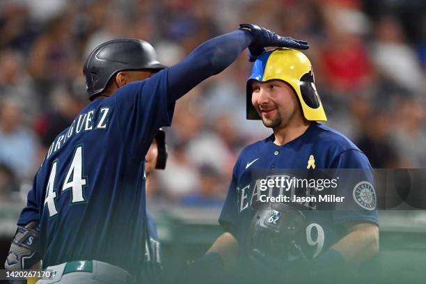 Jarret DeHart of the Seattle Mariners celebrates with Cal Raleigh after Raleigh hit a three-run home run during the sixth inning against the...