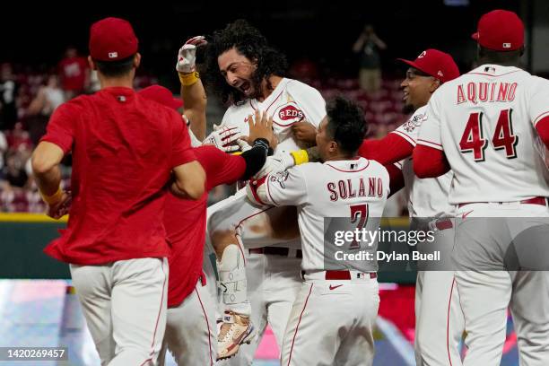 Jonathan India of the Cincinnati Reds celebrates with teammates after hitting a walk-off single in the ninth inning to beat the Colorado Rockies 3-2...