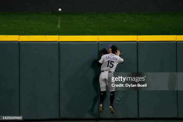 Randal Grichuk of the Colorado Rockies fails to catch a home run hit by Spencer Steer of the Cincinnati Reds in the fifth inning at Great American...