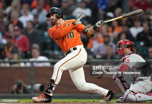 Evan Longoria of the San Francisco Giants hits an RBI double scoring Joc Pederson against the Philadelphia Phillies in the bottom of the first inning...