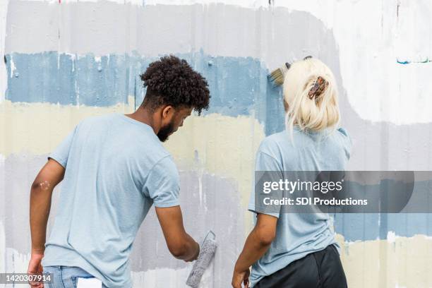 brother and sister working together - cleaning graffiti stock pictures, royalty-free photos & images