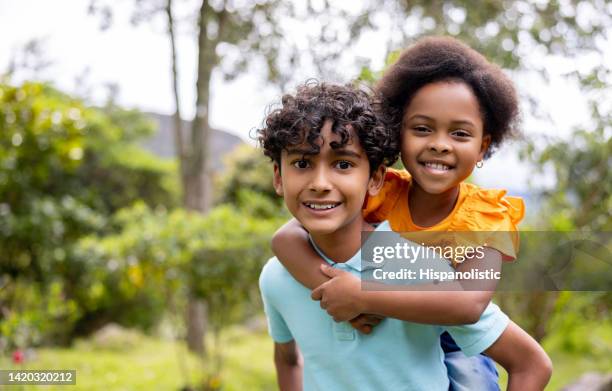 happy latin american children playing together outdoors - poor performance stock pictures, royalty-free photos & images