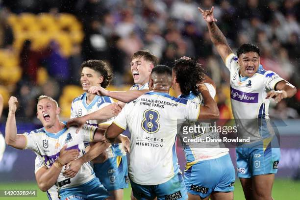 Tanah Boyd of the Titans celebrates with his team after winning the game with a drop goal in extra time during the round 25 NRL match between the New...