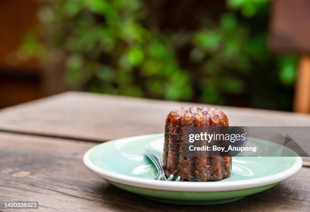 a dish of canele served on table. - canelé stock-fotos und bilder