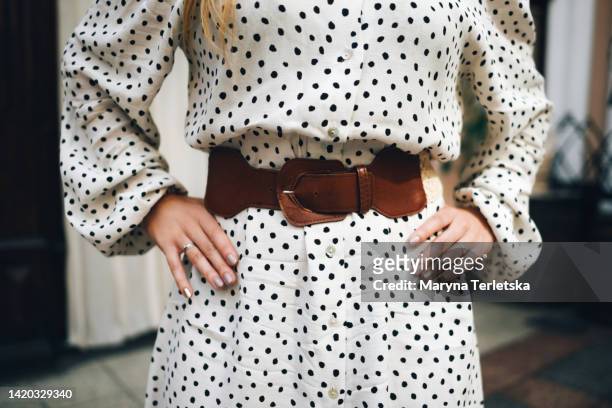 beautiful female hands with nude manicure. care and care of women's hands. manicurist. lifestyle. hands on the waist. hand position. beauty saloon. stylish look. - polka dot fashion stock pictures, royalty-free photos & images