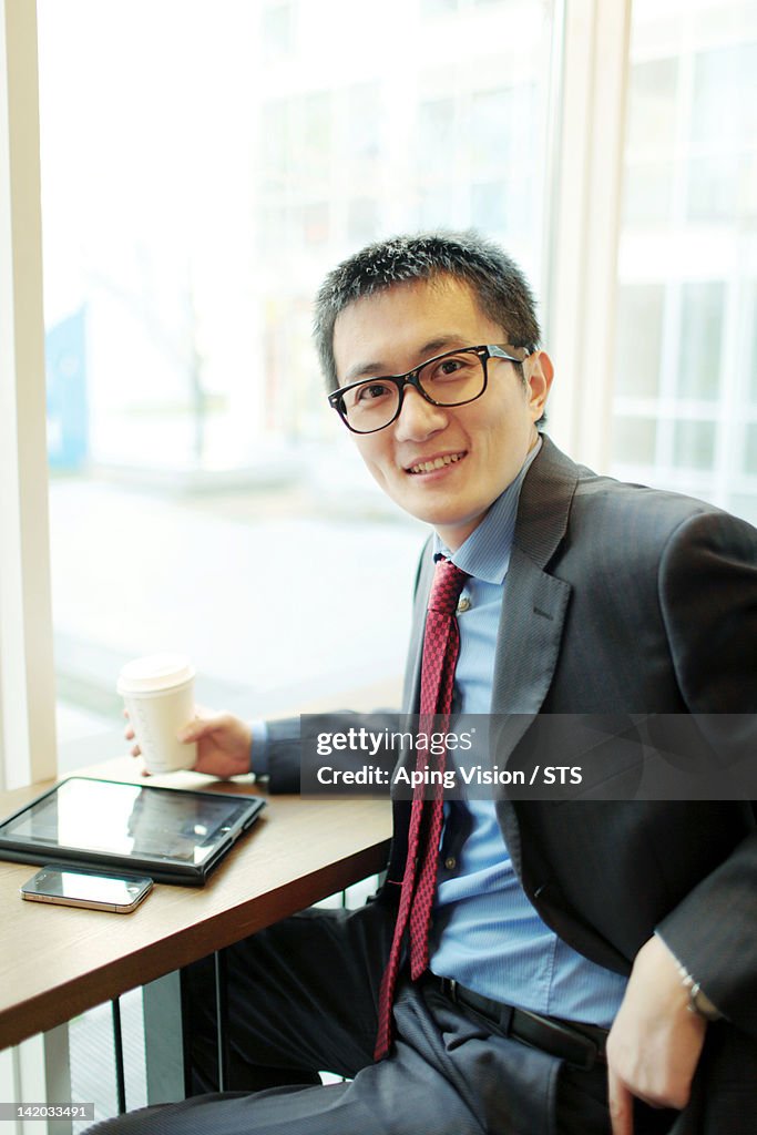 Asian businessman in coffee shop