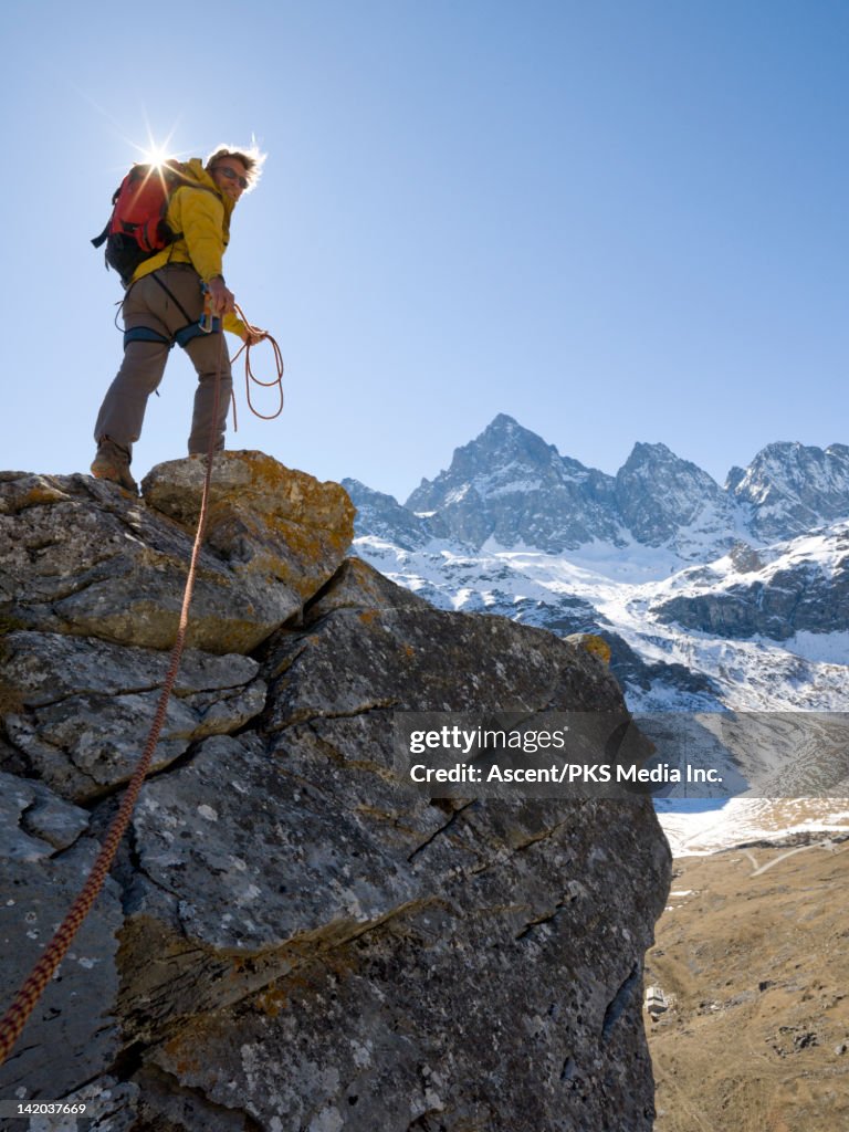 Mountaineer looks back to teammate from cliff edge