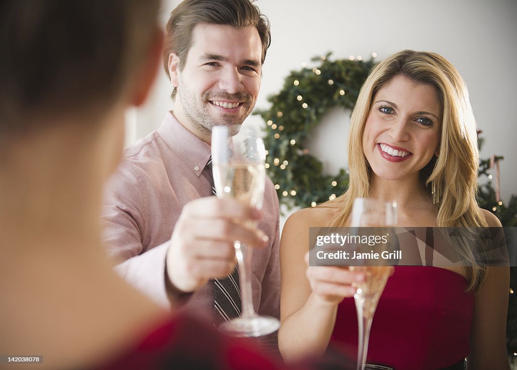 Couple toasting champagne at a party