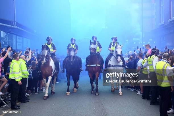 Police on horseback are seen outside the stadium as Everton fans wait for their team coach to arrive prior to the Premier League match between...