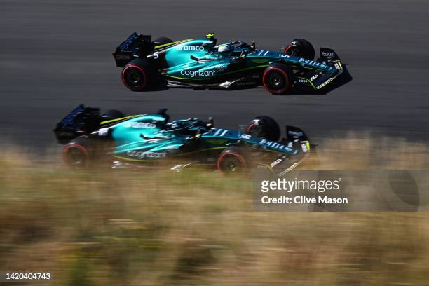 Sebastian Vettel of Germany driving the Aston Martin AMR22 Mercedes and Lance Stroll of Canada driving the Aston Martin AMR22 Mercedes on track...