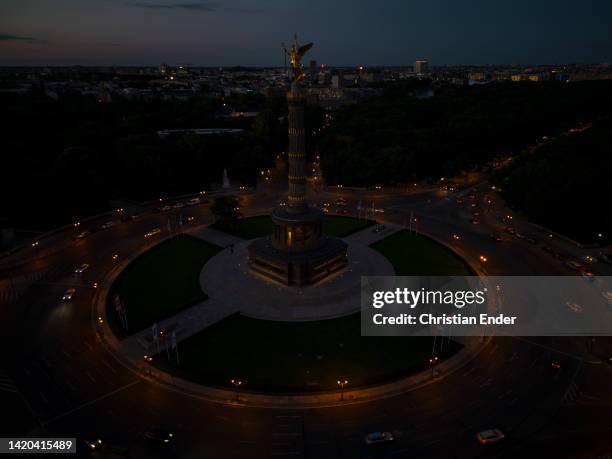 In this aerial view cars drive around the unlit Victory Column, one of Berlin's premiere landmarks, on the second day of a new law to save energy...