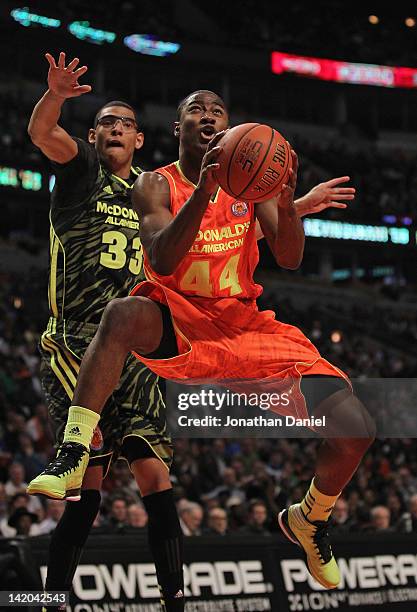 Rodney Purvis of the East team drives to the basket past Isaiah Austin of the West team during the 2012 McDonald's All American Game at United Center...