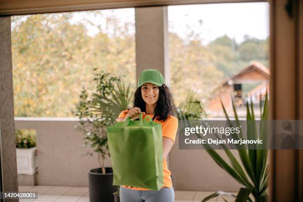 woman delivery person - showing id stock pictures, royalty-free photos & images