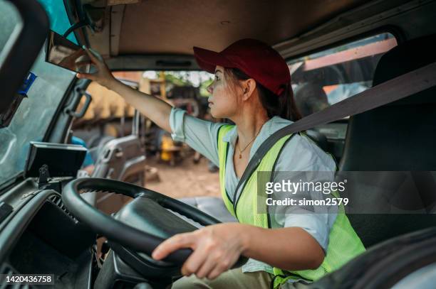 mid 30s asian chinese female truck driver preparing to leave on road trip - trucking stock pictures, royalty-free photos & images