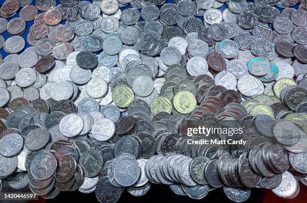 Ten pence loose coins are stacked inside a coin pusher machine in an amusement arcade in Penzance, on August 15, 2022 in Cornwall, England. The UK is...