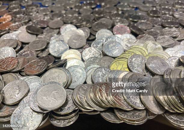 Ten pence loose coins are stacked inside a coin pusher machine in an amusement arcade in Penzance, on August 15, 2022 in Cornwall, England. The UK is...