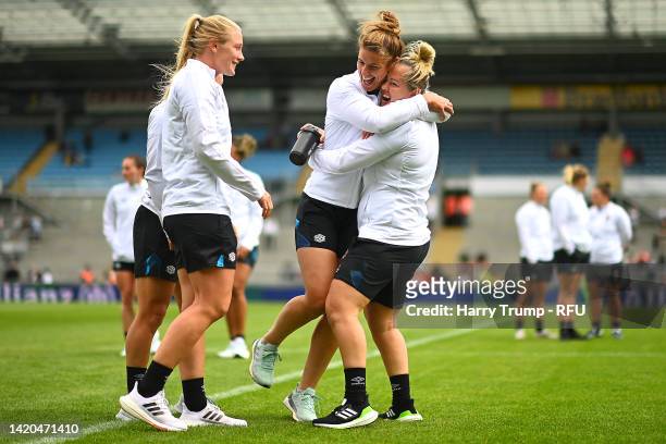 Alex Matthews looks on as Sarah Hunter interacts with Marlie Packer of England prior to kick off of the Women's International rugby match between...