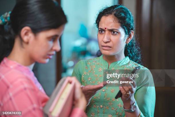 woman tries to convince her niece to focus on her studies. - indian aunt stock pictures, royalty-free photos & images