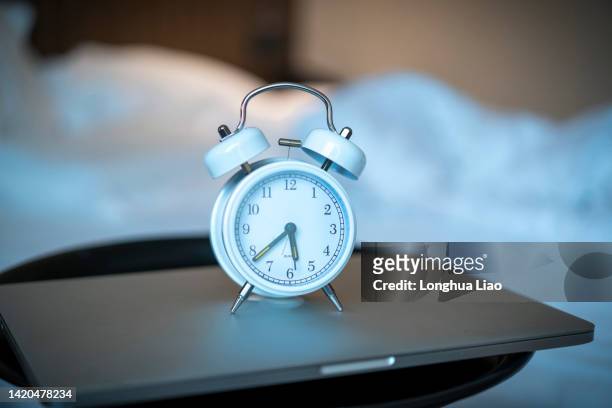 an alarm clock by the bed - alarm clock on nightstand stock pictures, royalty-free photos & images