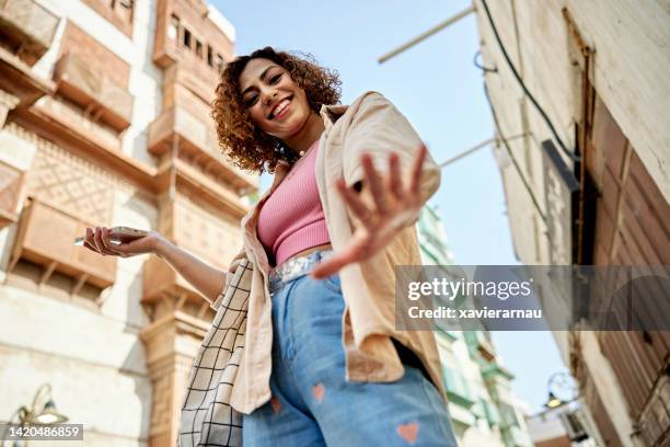 cheerful portrait of middle eastern woman in jeddah - middle east clothing stock pictures, royalty-free photos & images