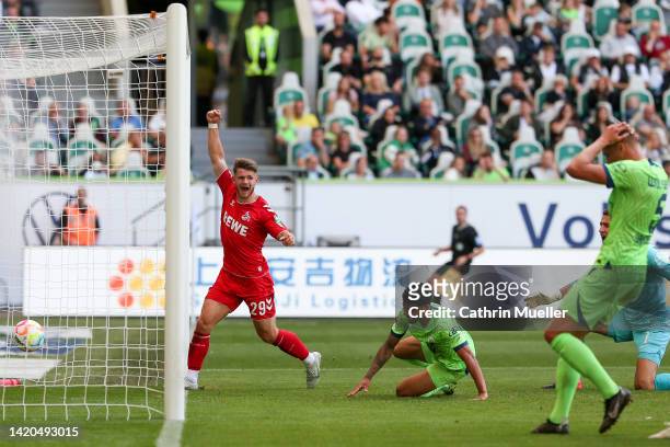 Jan Thielmann of 1.FC Köln celebrates after Paulo Otavio of VfL Wolfsburg concedes an own goal during the Bundesliga match between VfL Wolfsburg and...