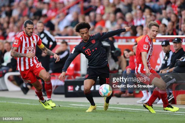 Leroy Sane of Bayern Munich is put under pressure by Christopher Trimmel and Paul Jaeckel of FC Union Berlin during the Bundesliga match between 1....