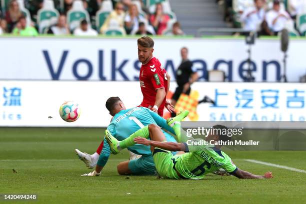 Jan Thielmann of 1.FC Köln looks on as Paulo Otavio of VfL Wolfsburg concedes an own goal during the Bundesliga match between VfL Wolfsburg and 1. FC...