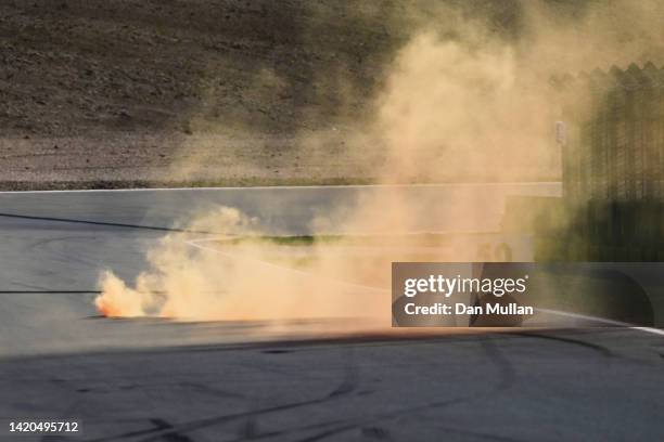 An orange flare is pictured on track during qualifying ahead of the F1 Grand Prix of The Netherlands at Circuit Zandvoort on September 03, 2022 in...