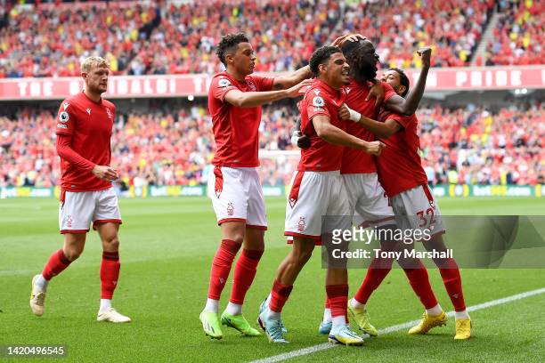 Cheikhou Kouyate of Nottingham Forest celebrates with teammates after scoring their team's first goal during the Premier League match between...