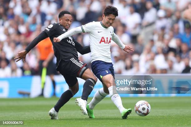 Son Heung-Min of Tottenham Hotspur is tackled by Kenny Tete of Fulham during the Premier League match between Tottenham Hotspur and Fulham FC at...