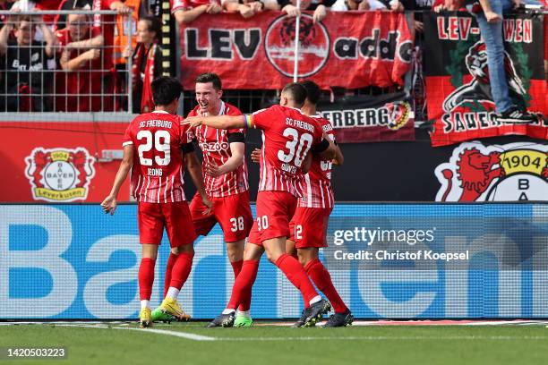 Michael Gregoritsch of SC Freiburg celebrates with teammates after scoring their team's second goal during the Bundesliga match between Bayer 04...