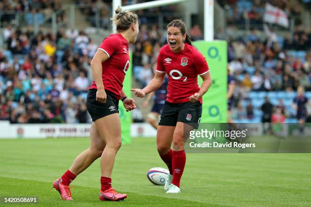 Claudia MacDonald of England celebrates scoring their side's sixth try with Leanne Infante during the Women's International rugby match between...