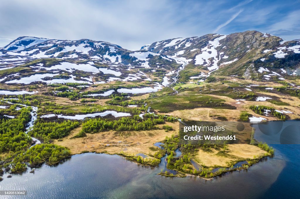 Norway, Vestland, Drone view of lakeshore in Filefjell range