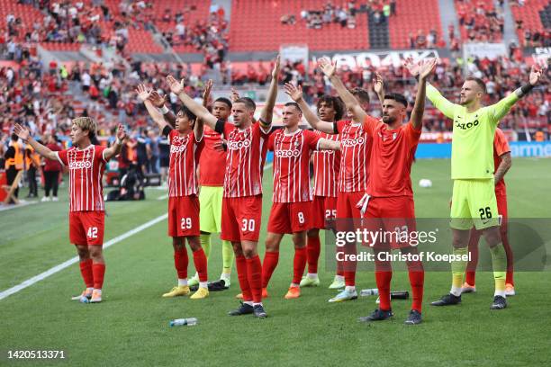 The team of Freiburg celebrates wit the fans after winning 3-2 the Bundesliga match between Bayer 04 Leverkusen and Sport-Club Freiburg at BayArena...