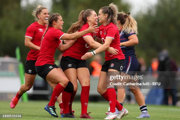 Ellie Kildunne of England celebrates scoring their side's eighth try with teammates during the Women's International rugby match between England Red...