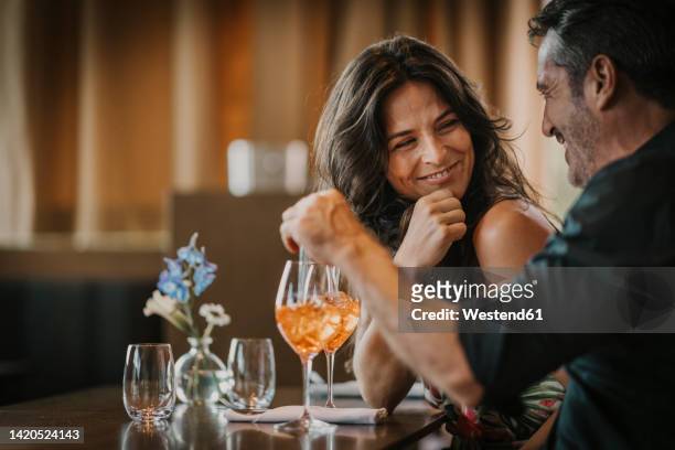 happy mature couple enjoying drink in restaurant - couples dating stock pictures, royalty-free photos & images