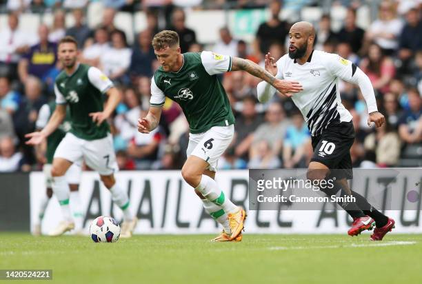 Dan Scarr of Plymouth Argyle is challenged by David Mcgoldrich of Derby County during the Sky Bet League One between Derby County and Plymouth Argyle...