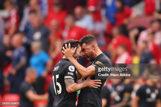 Adam Smith and Ryan Fredericks of AFC Bournemouth celebrate victory following the Premier League match between Nottingham Forest and AFC Bournemouth...