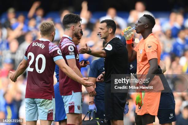 Jarrod Bowen and Declan Rice of West Ham United speak to Referee Andy Madley after a VAR decision ruled out a West Ham United goal by Maxwel Cornet...