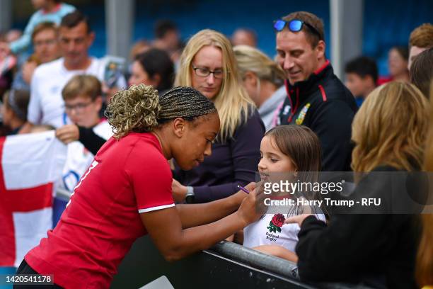 Sadia Kabeya of England signs the shirt of fan of England after the final whistle of the Women's International rugby match between England Red Roses...