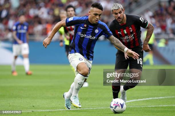 Lautaro Martinez of FC Internazionale is challenged by Theo Hernandez of AC Milan during the Serie A match between AC Milan and FC Internazionale at...