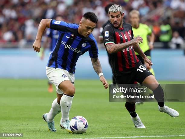 Lautaro Martinez of FC Internazionale is challenged by Theo Hernandez of AC Milan during the Serie A match between AC Milan and FC Internazionale at...