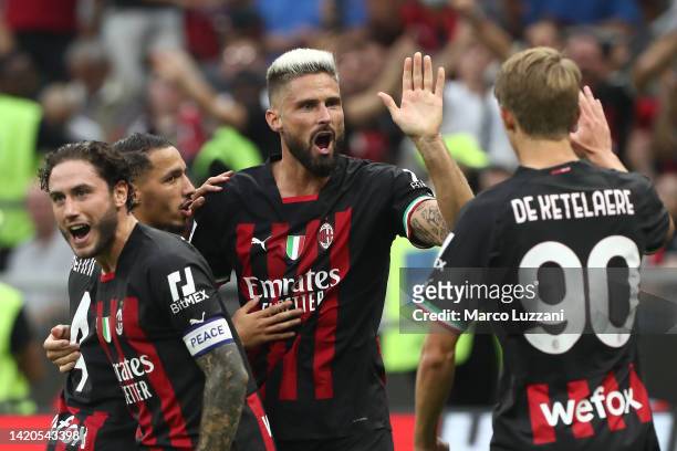 Olivier Giroud of AC Milan celebrates scoring their side's third goal with teammates during the Serie A match between AC Milan and FC Internazionale...