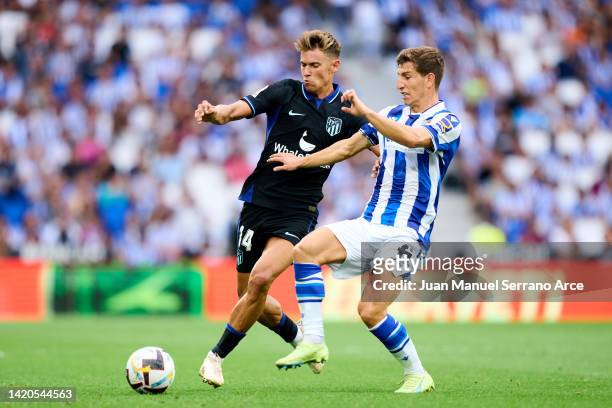 Aihen Munoz of Real Sociedad duels for the ball with Marcos Llorente of Club Atletico de Madrid during the LaLiga Santander match between Real...