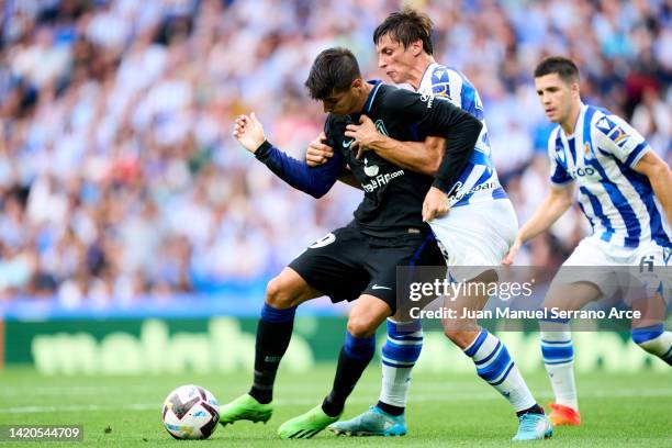 Robin Le Normand of Real Sociedad duels for the ball with Alvaro Morata of Club Atletico de Madrid during the LaLiga Santander match between Real...