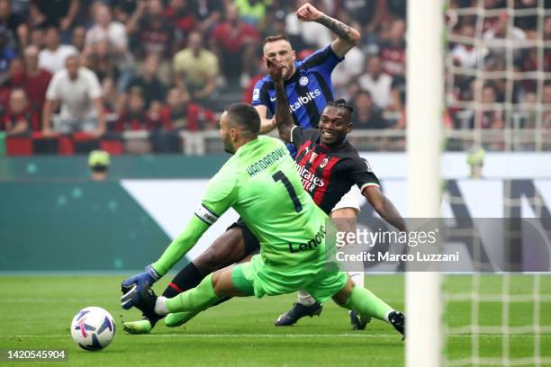 Rafael Leao of AC Milan scores their side's third goal whilst under pressure from Samir Handanovic of FC Internazionale during the Serie A match...